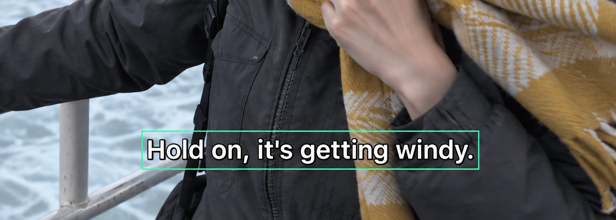 Close-up illustration of white dialogue text and its dark outline, both included in the selection over a jacket and scarf